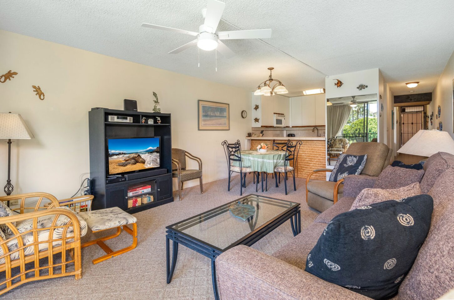 Living room with 40 inch TV, queen sofa bed, dining and kitchen