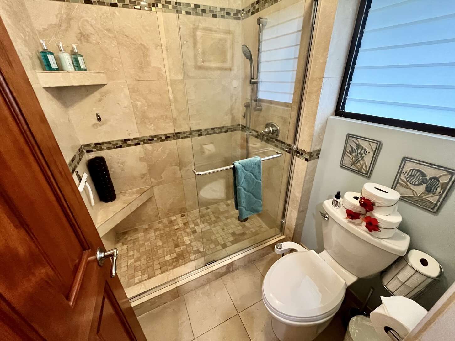Relax and unwind in a serene bathroom retreat, featuring a spacious walk-in shower stocked with all your shower essentials for a comfortable stay