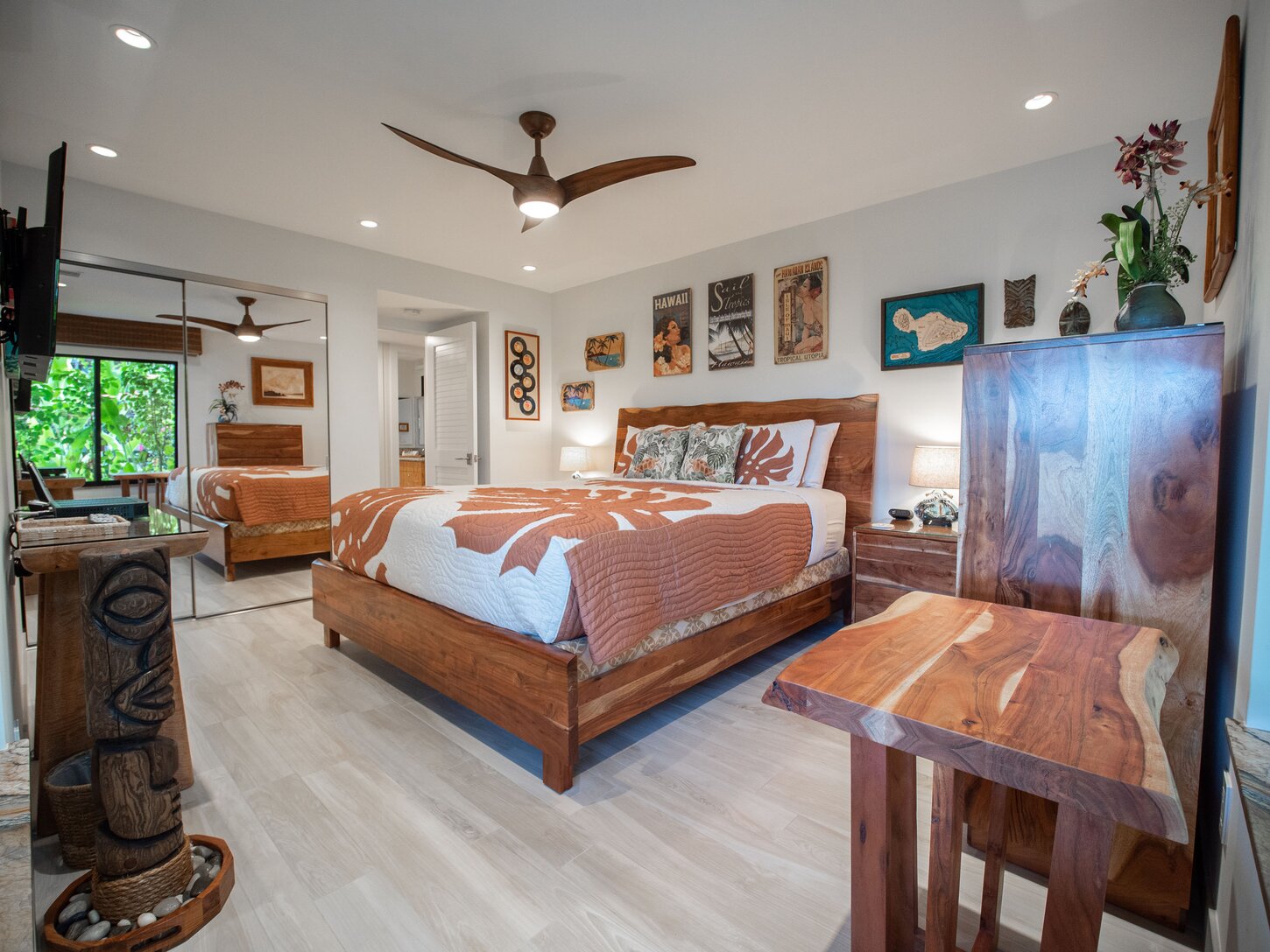 Luxury guest bedroom features a king bed, and live-edge, solid acacia wood furnishings