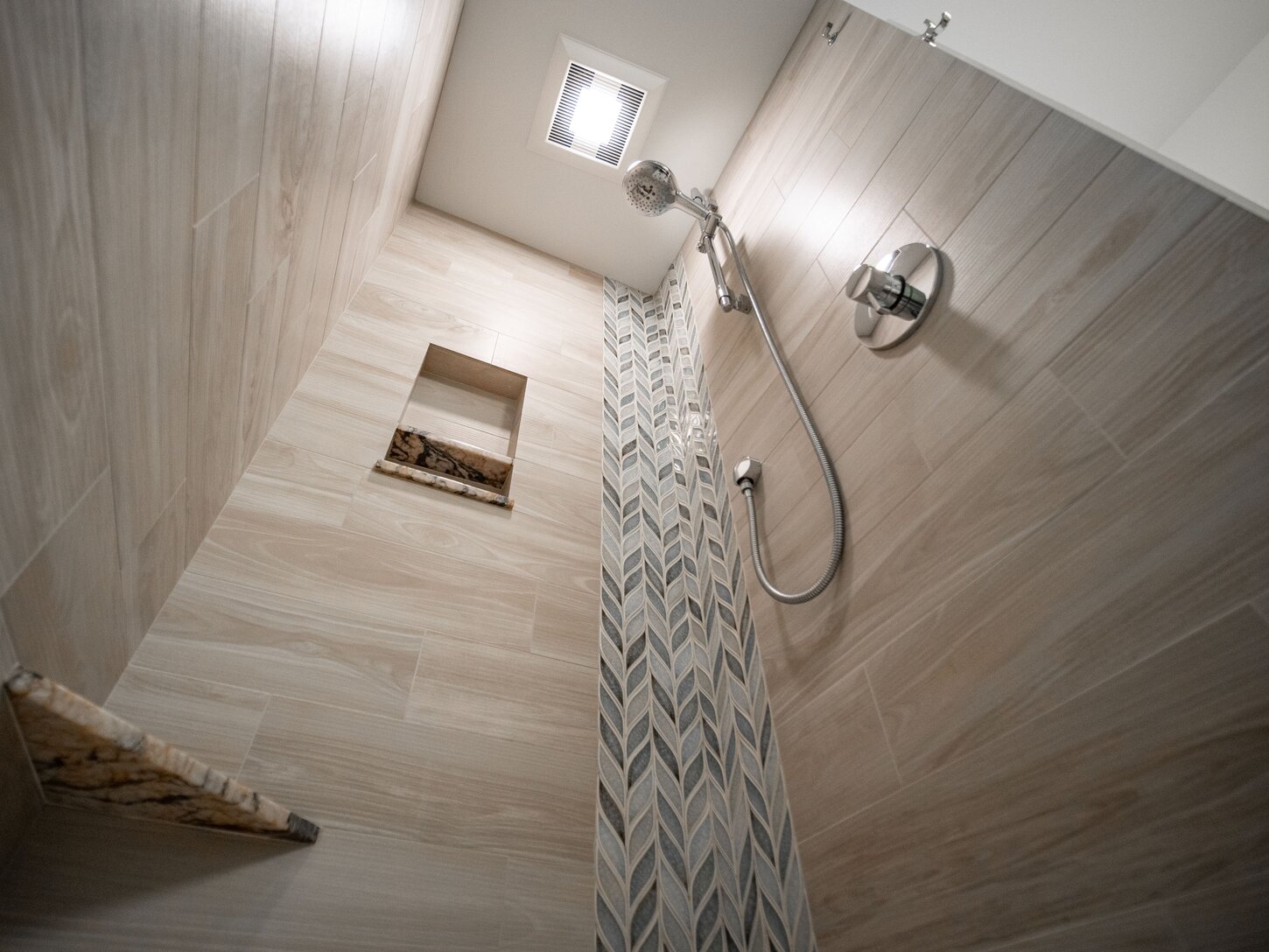 Guest bathroom shower features beautiful accent tile