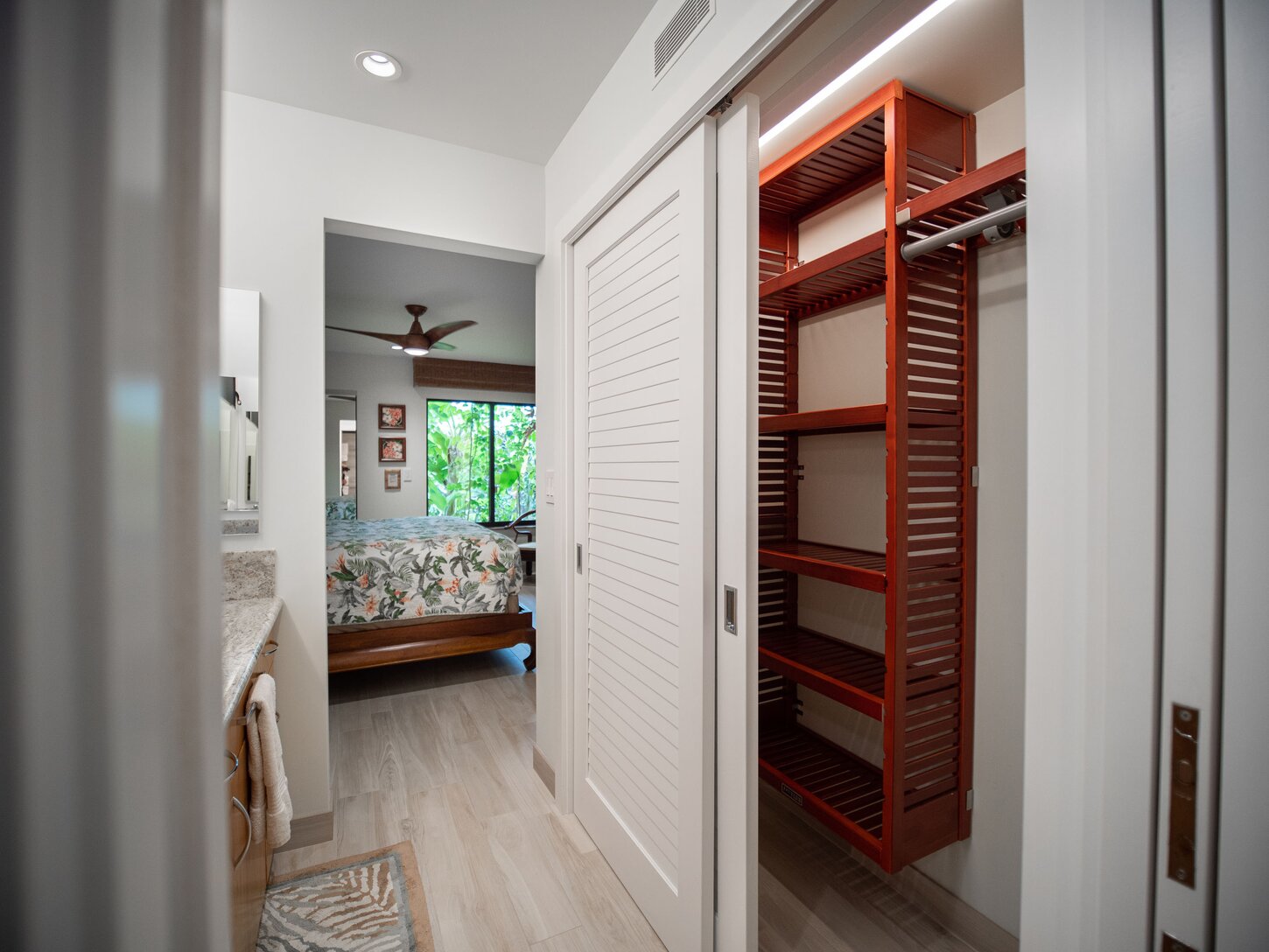 Master bathroom vanity area features ample storage and closet space