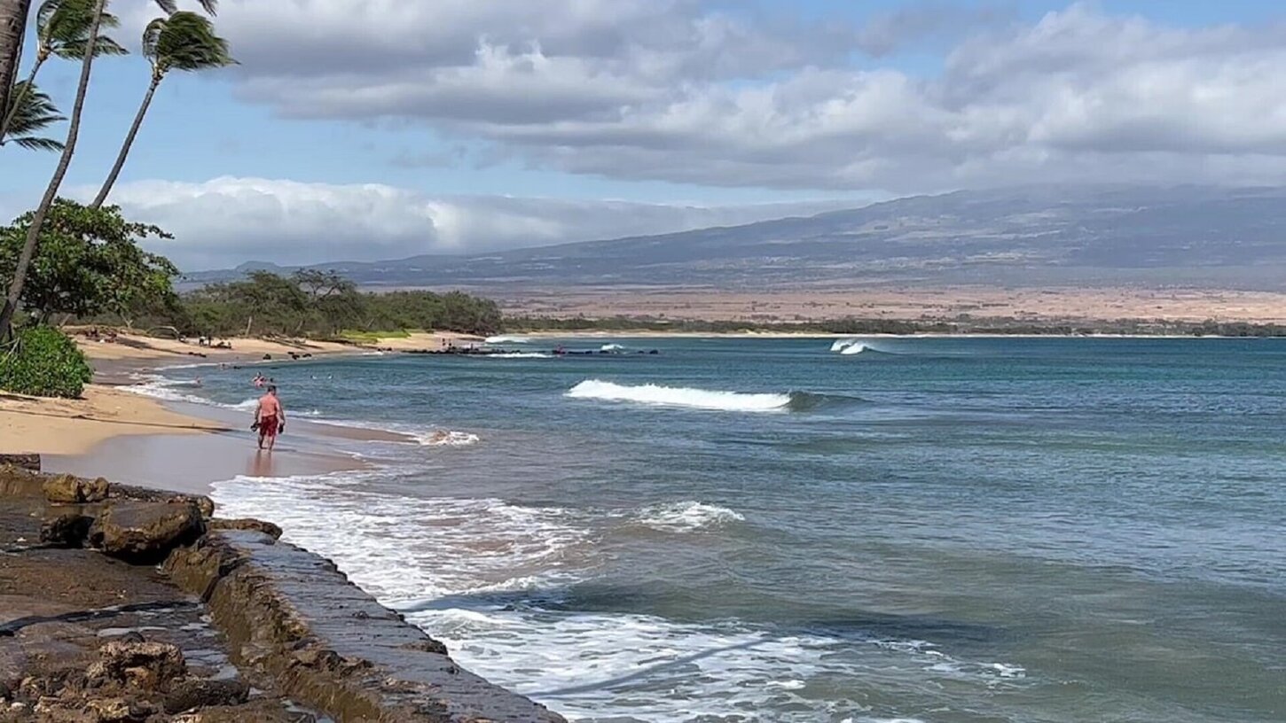 A guest enters Sugar Beach, between the seawalls.