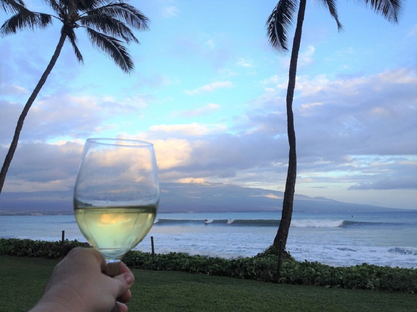 Sunset on the lanai. Raise a glass to the breath-taking views and the surfers.