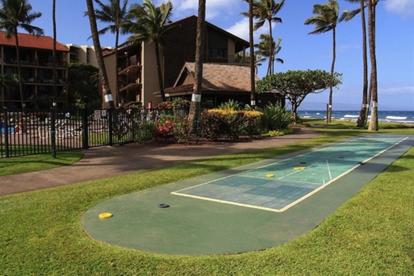 Two lawn shuffle board courts next to each pool at the Papakea