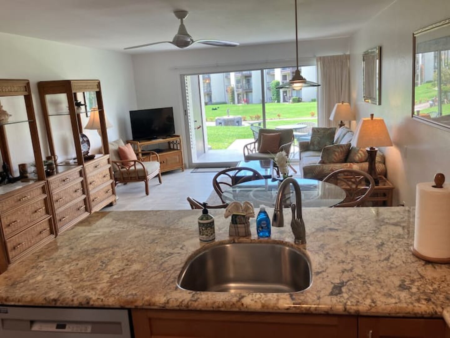 View from kitchen includes one of 2 common grill areas and sofa sleeper in living room