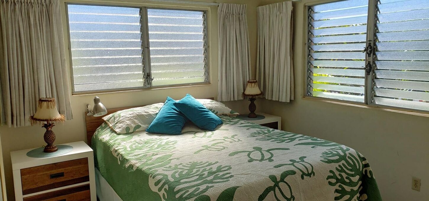 Bedroom with a queen size bed.  A corner unit with the extra window and often watching beautiful sunsets.  Also an ocean view when bushes are trimmed.